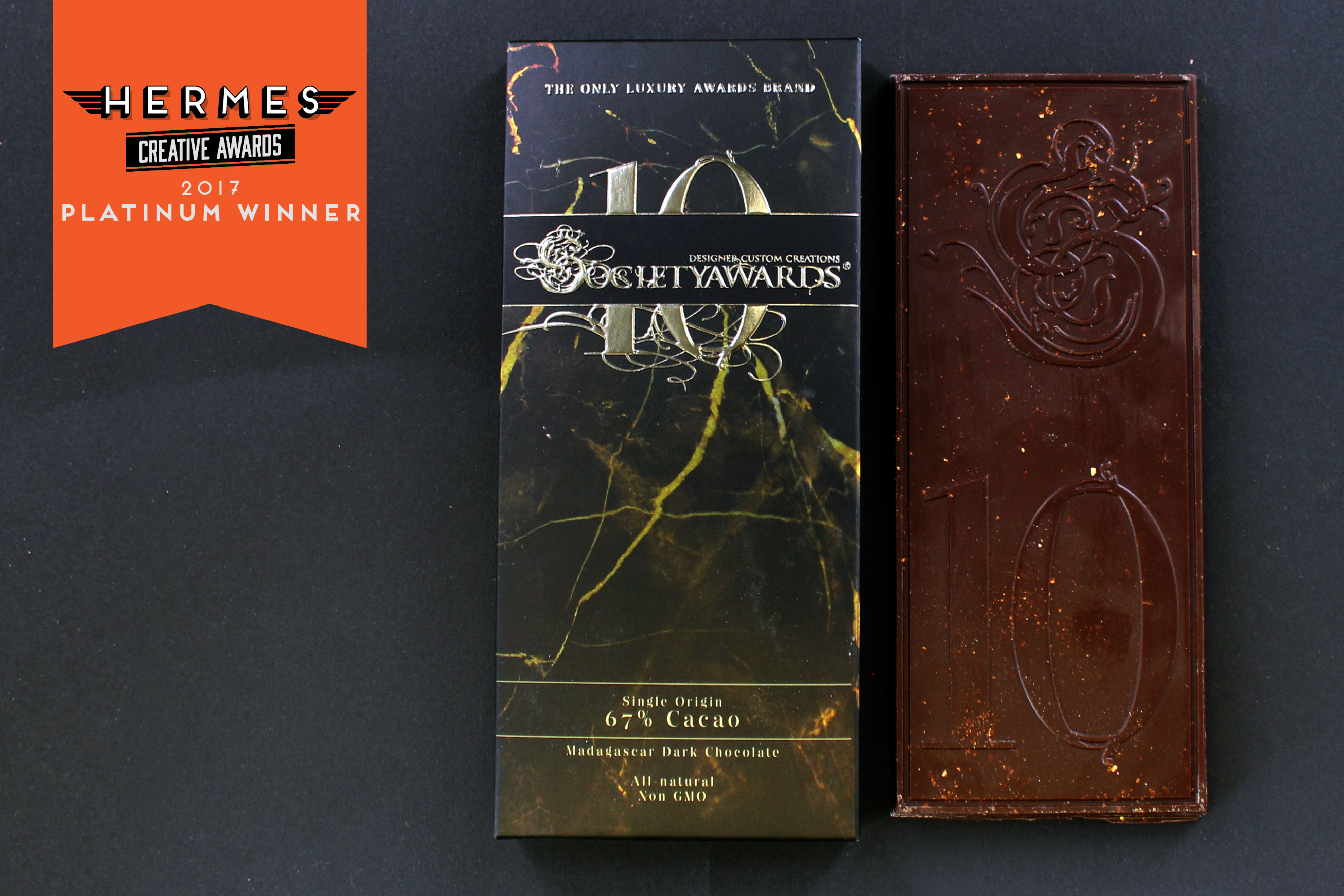 Chocolate bar with edible gold leaf and custom packaging created for our 10 Year Anniversary. Winner of Hermes Platinum Award