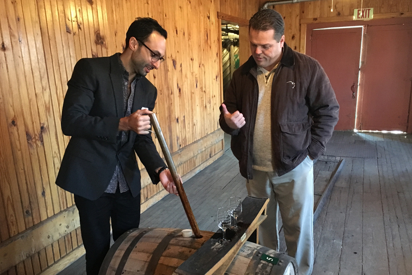 CEO David Moritz using a copper whiskey thief to pull Eagle Rare bourbon from a barrel at the Buffalo Trace Distillery