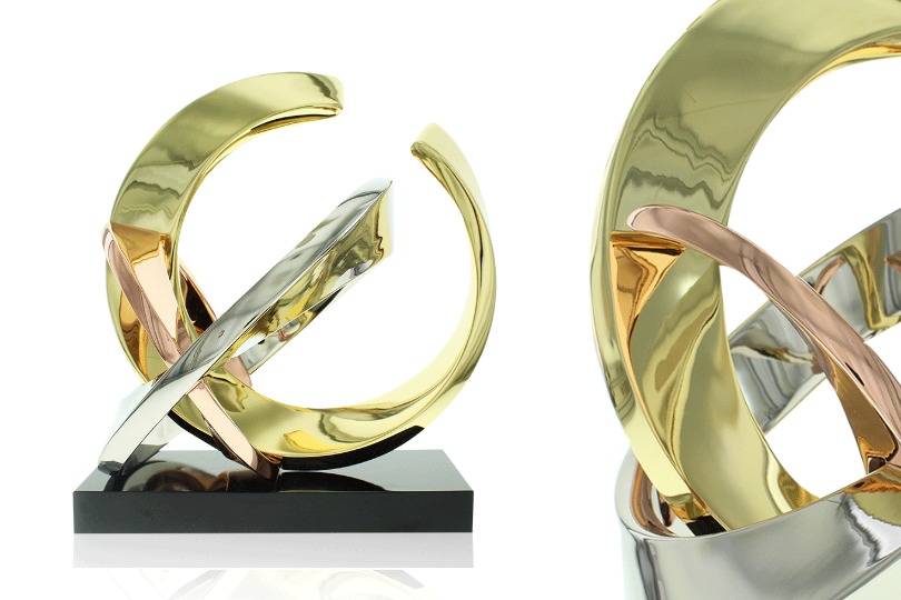 2 views of limited edition Rings 1 award made up of 3 rings of varied size in 24k gold, polished chrome, rose gold
