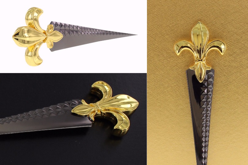 Custom dagger-shaped letter opener with 24k gold plating, fleur de lis handle and stud detail.
