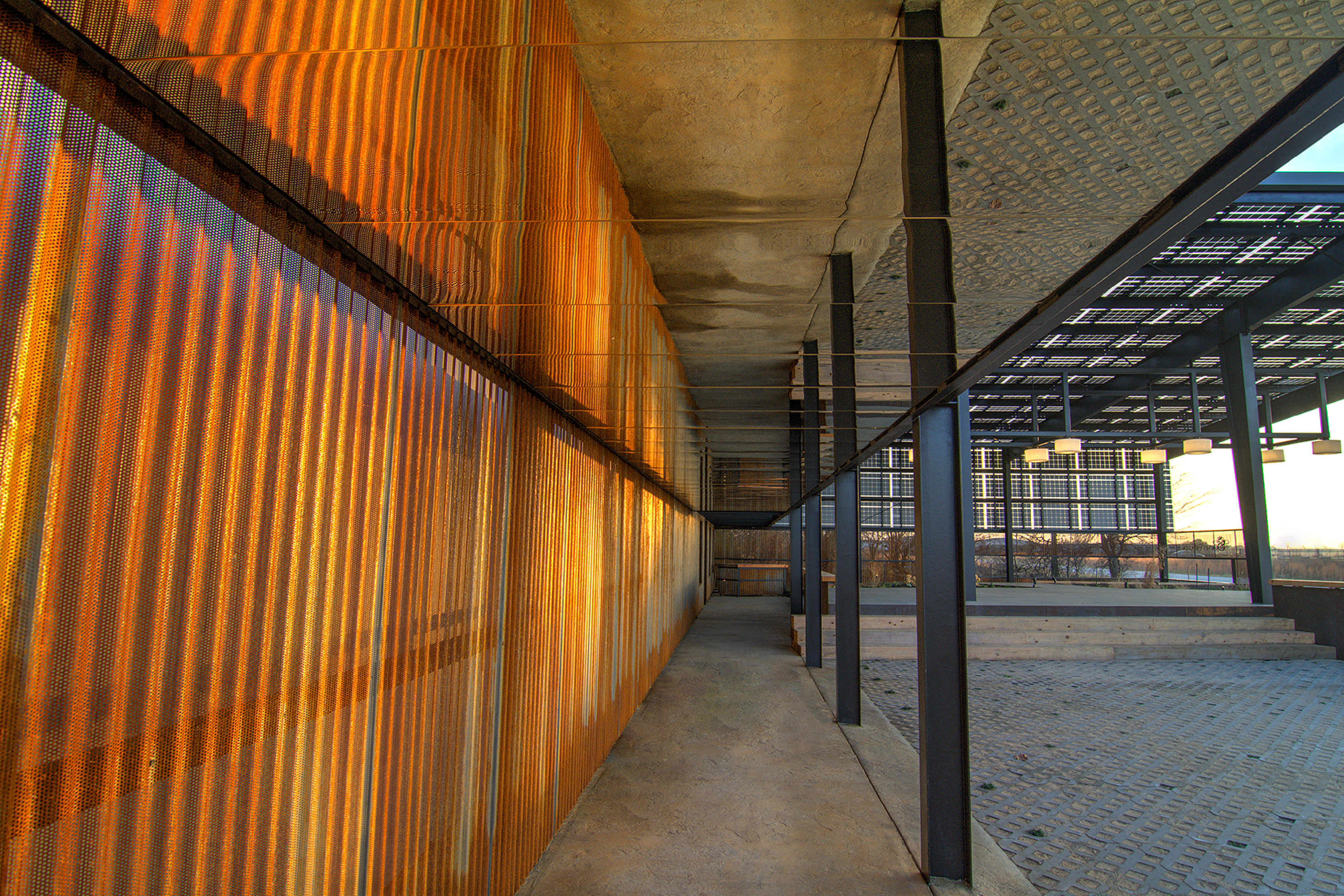 Gold glass panels line the walkway along the Society Awards Production Facility in Grove, OK